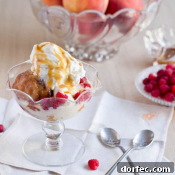 Deep fried peaches served with a scoop of vanilla ice cream, drizzled with sauce.