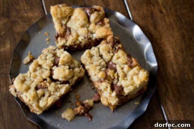 Twix Caramel Shortbread Bars 5 You will fall in love with these #Reeses Crumble bars. Buttery oatmeal cumble stuffed with chocolate chips and #Reesespeanutbuttercups ohsweetbasil.com_