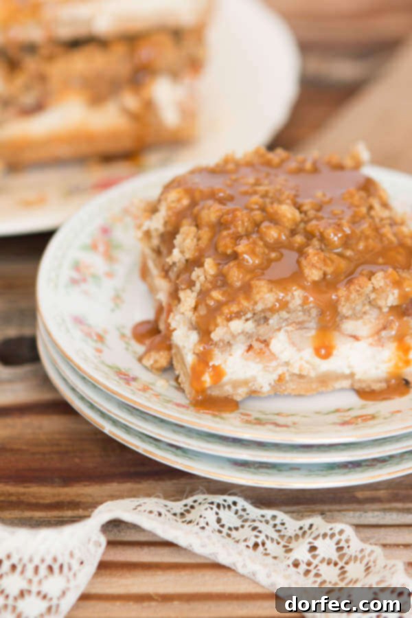 Close-up of baked Cheesecake Caramel Apple Crisp Bars showcasing the layers and walnut oat topping.