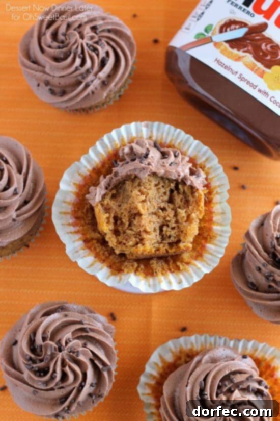 Several Pumpkin Cupcakes with Nutella Frosting on a cooling rack