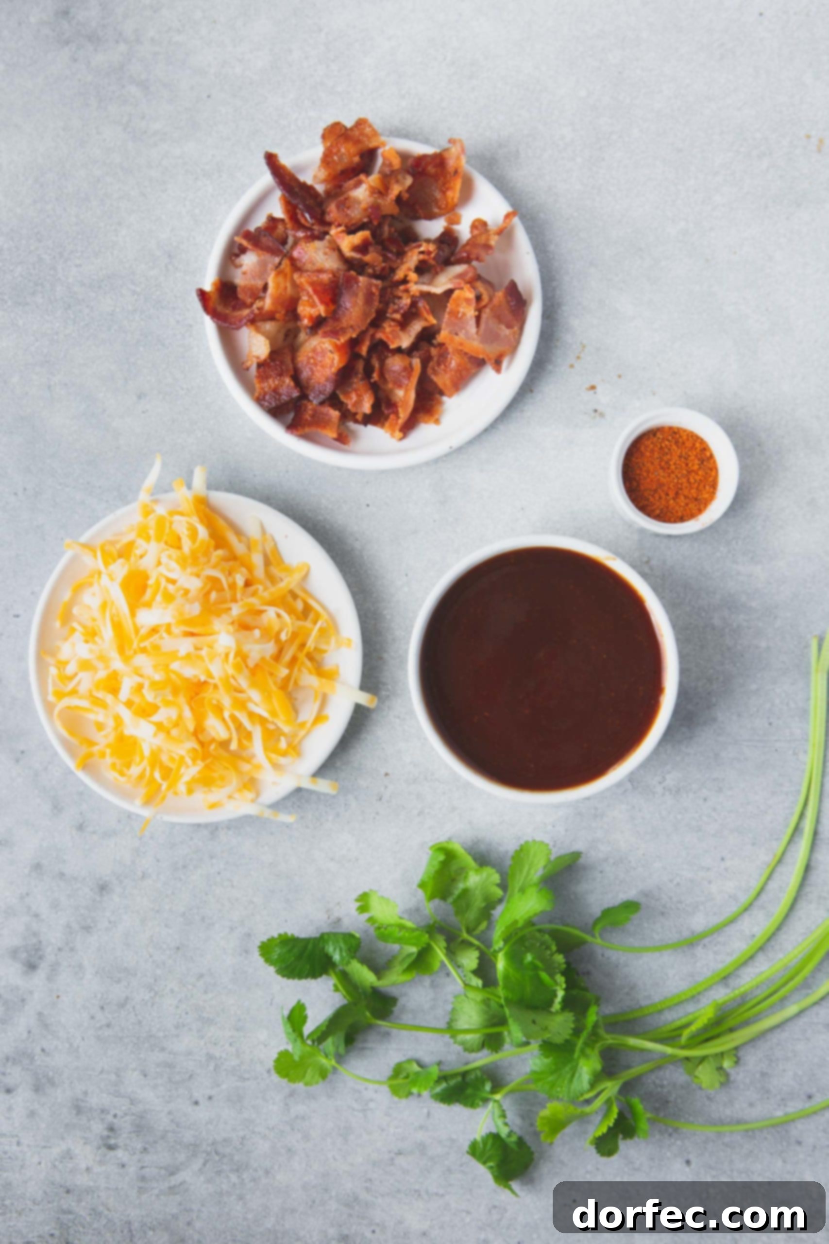 Cheesy Bacon BBQ Chicken Bowls filled with fresh ingredients for Cheesy Bacon BBQ Chicken: grated Colby Jack cheese, rich BBQ sauce, crispy bacon bits, and a vibrant spice blend.