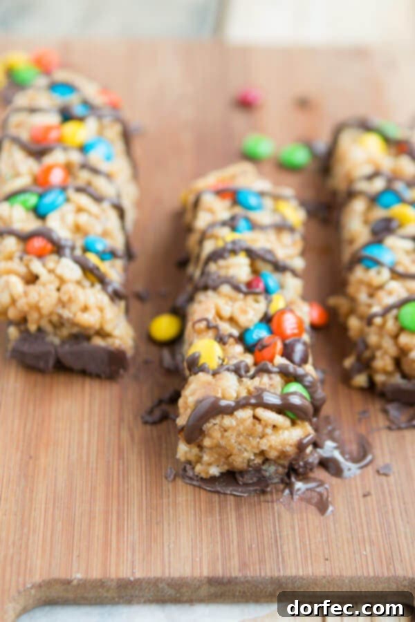 Homemade Peanut Butter M&M Kudos Bars 3 A closer view of the crispy, chocolate-covered Peanut Butter M&M Kudos Copycat bars, highlighting their delectable texture.