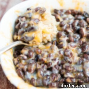 Cheesy Black Beans and Rice recipe card image.
