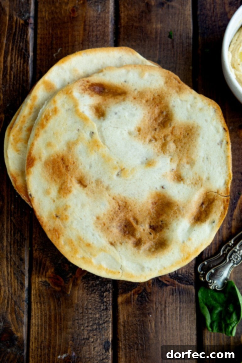 A photo of a pile of toasted circular flatbreads stacked on each other, showing a potential base for the tostadas.