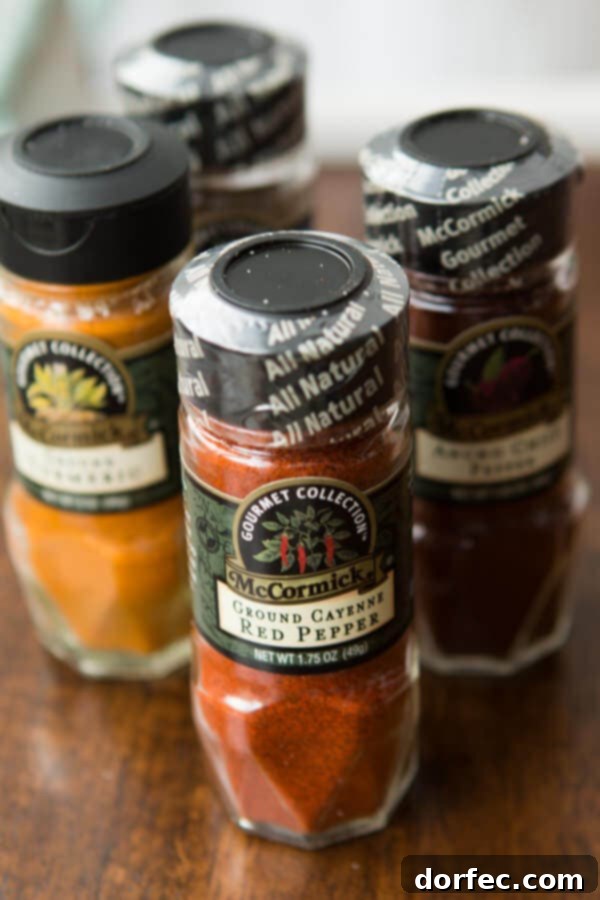 Embrace Winter's Flavor with McCormick Gourmet Spices A person preparing to cook with various McCormick Gourmet Spices, symbolizing the cozy warmth of winter and culinary creativity.