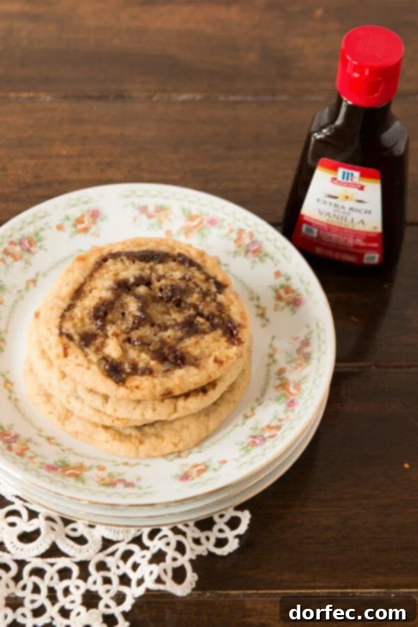 plate of Pinwheel Cookies next to bottle of vanilla extract