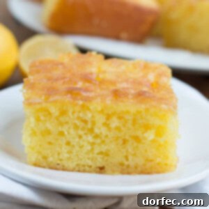 Slice of Lemon Jello Cake on a white plate.