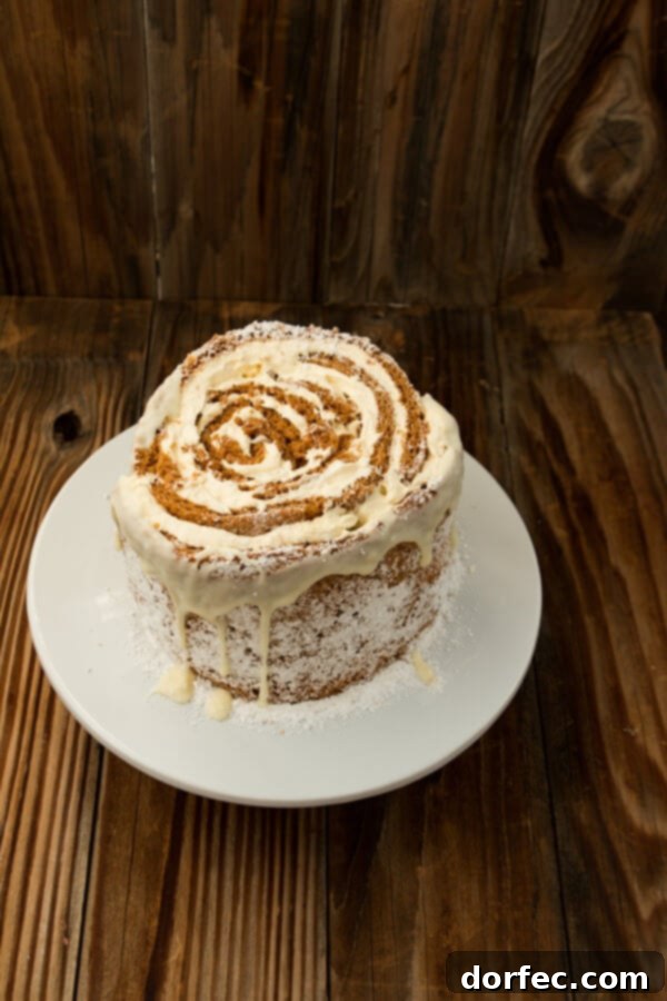 Dessert for a Holiday Party Finished Pumpkin Roll White Chocolate Cake drizzled with white chocolate.