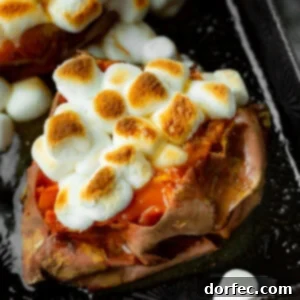 a photo of a baked sweet potato topped with butter and toasted mini marshmallows