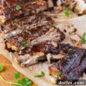 A close-up of Asian Sticky Slow Cooker Ribs, perfectly glazed and ready to be enjoyed