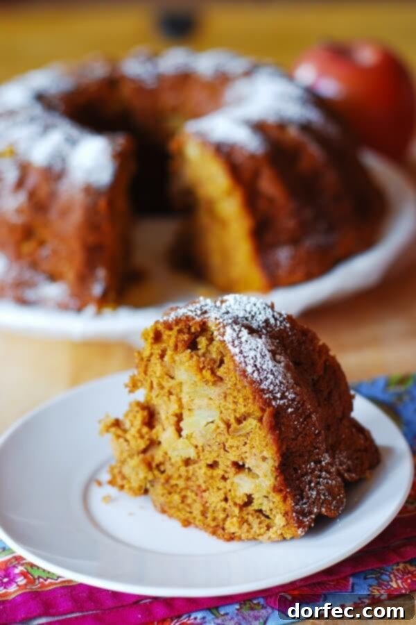 A freshly baked Apple Pumpkin Spice Bundt Cake, cooling on a wire rack before serving.