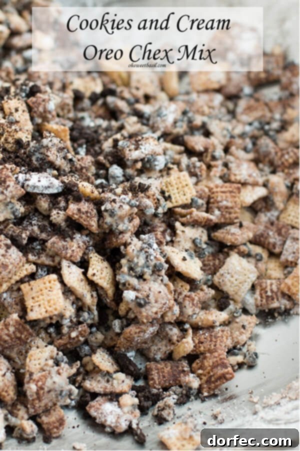 Our kids beg for this cookies and cream oreo chex mix by ohsweetbasil.com, featuring a close-up of the cereal mix with Oreo pieces.
