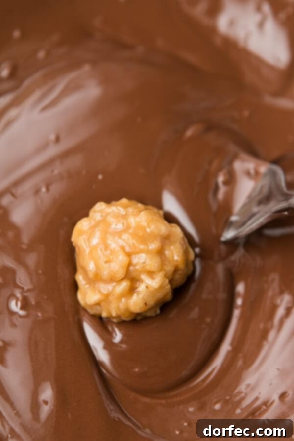 Close-up of a Scotcheroo Millionaire Nugget, showcasing its delicious layers of peanut butter, rice cereal, and chocolate