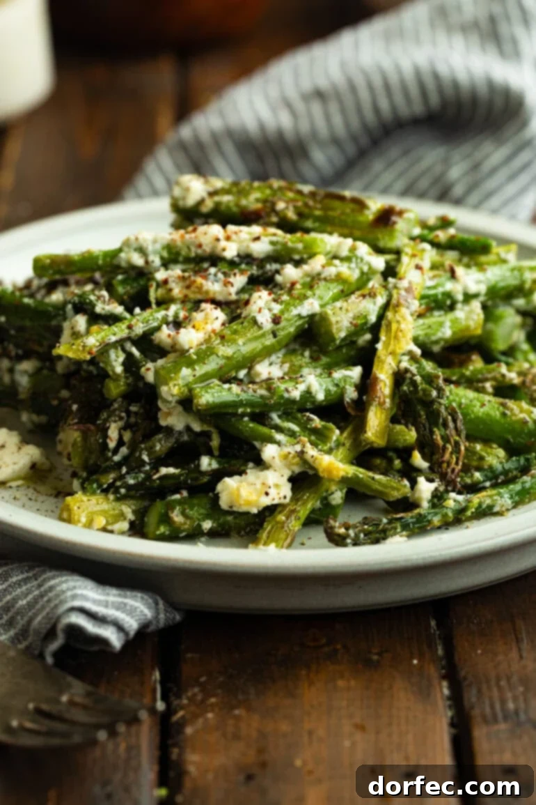 Zesty 5-Minute Lemon Feta Grilled Asparagus 3 A close-up photo of a serving plate filled with perfectly grilled asparagus spears, lightly tossed with crumbled feta cheese and bright lemon zest.