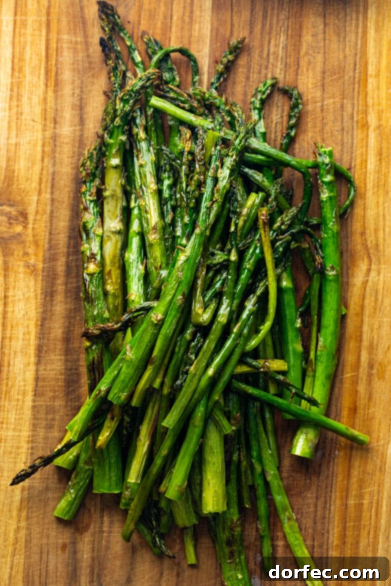 Zesty 5-Minute Lemon Feta Grilled Asparagus 6 A close-up shot of grilled asparagus, beautifully charred and tender, showcasing the simple yet effective cooking process.