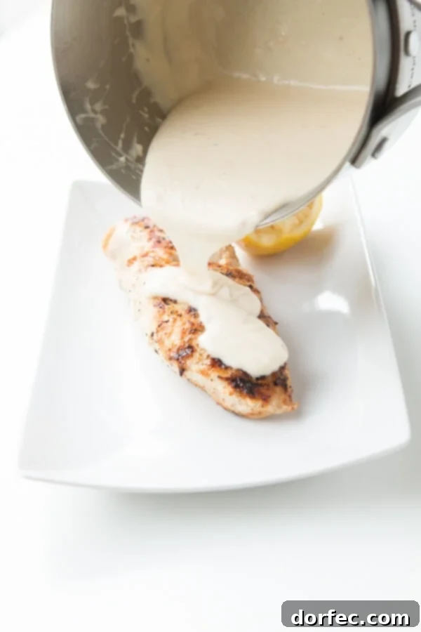 Close-up of grilled chicken drizzled with luscious lemon cream sauce