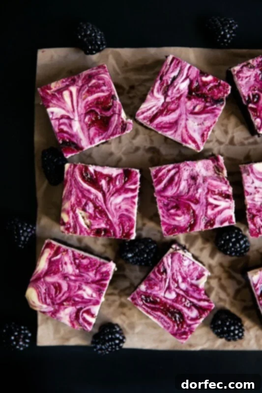 Blackberry cheesecake brownies that will have everyone begging for seconds, cut into squares and ready to serve.
