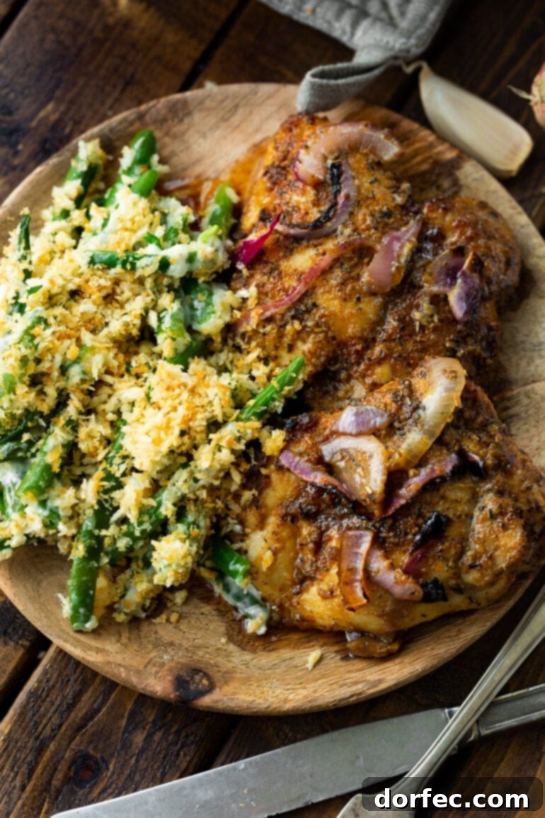 A perfectly baked boneless, skinless chicken thigh, golden brown and seasoned.