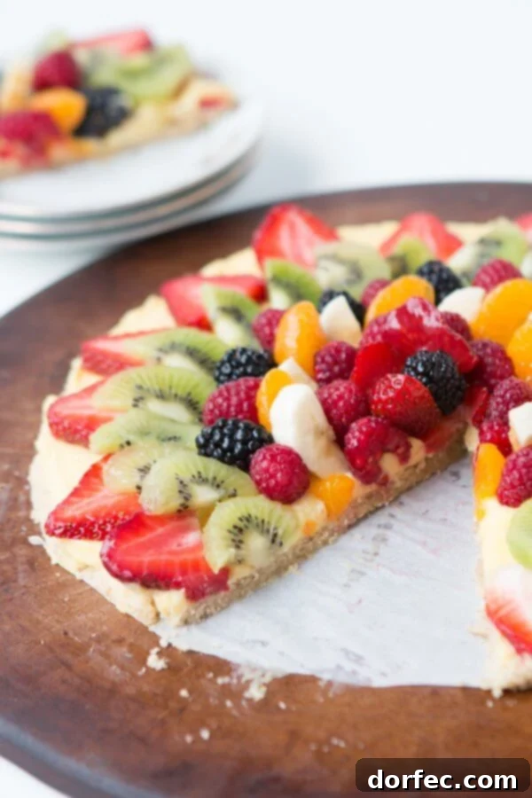 A close-up of Mom's famous fruit pizza, showcasing the vibrant array of fresh fruits and the delicious oat cookie crust.