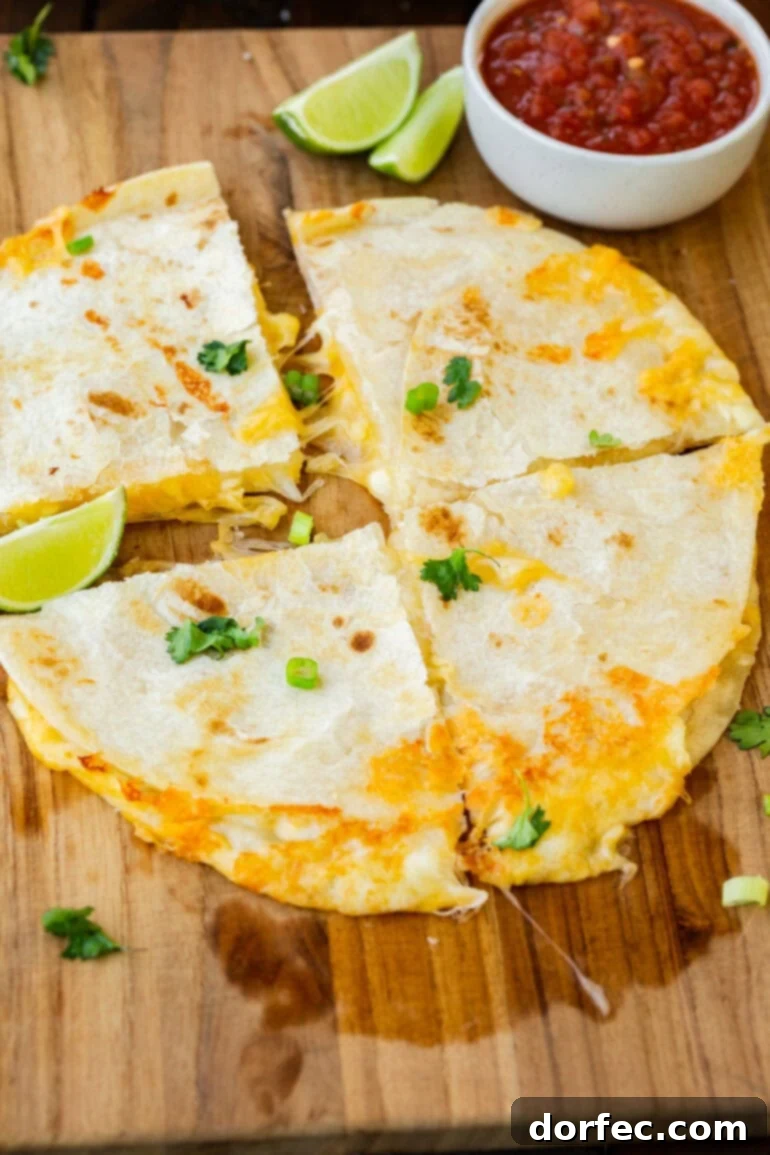A golden flour tortilla cheese quesadilla, perfectly cut into quarters and ready to serve.