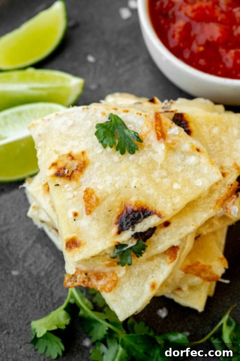 A stack of perfectly cooked corn tortilla quesadilla pieces, ready to be enjoyed.
