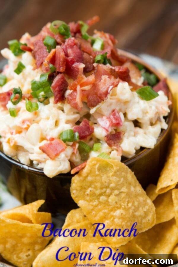 Bacon Ranch Corn Dip ohsweetbasil.com Close-up of a cold corn dip in a rustic dark bowl, surrounded by crispy tortilla chips, highlighting the vibrant colors and creamy texture.