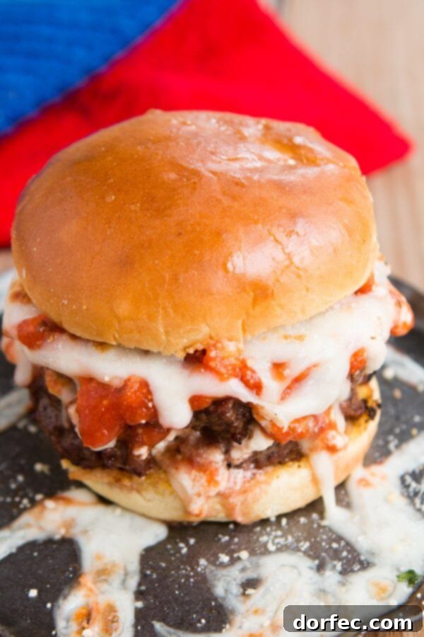 Lasagna Burger: Italian beef, ricotta, sauce, and mozzarella on herbed garlic bread buns. Rich, savory Italian beef patties layered with creamy ricotta, tangy marinara sauce, and gooey mozzarella cheese, all nestled between toasted herbed garlic bread buns. A perfect summer twist on classic lasagna and burgers.