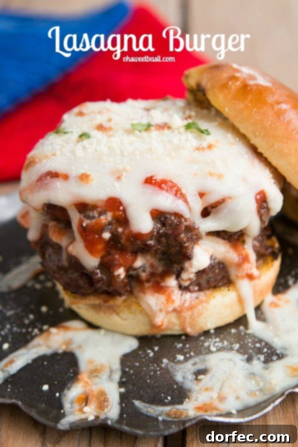 Layers of deliciousness: ricotta, sauce, mozzarella on Italian beef for Lasagna burgers! Close-up of a Lasagna Burger, showcasing the layers of Italian beef, ricotta, marinara, and melted mozzarella, served on crispy garlic bread buns.
