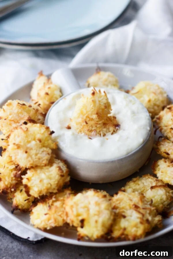 Baked Coconut Shrimp with Tropical Dipping Sauce is sure to be your favorite summer dinner. Crunchy shrimp that are so easy and much healthier!
