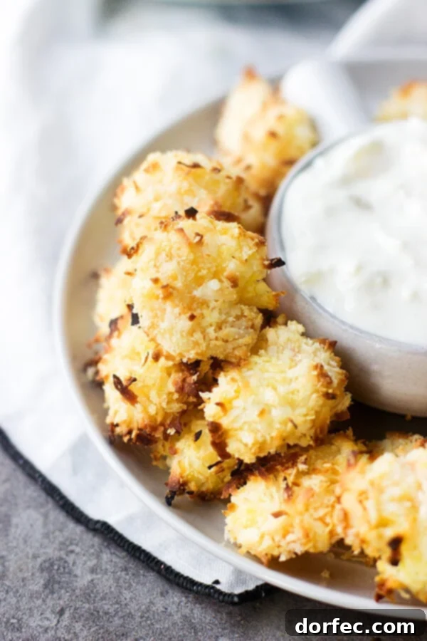 Baked Coconut Shrimp with Tropical Dipping Sauce is sure to be your favorite summer dinner. Crunchy shrimp that are so easy and much healthier!