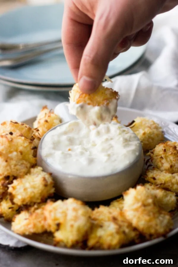 Baked Coconut Shrimp with Tropical Dipping Sauce is sure to be your favorite summer dinner. Crunchy shrimp that are so easy and much healthier!