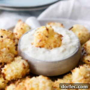 Baked Coconut Shrimp with Tropical Dipping Sauce is sure to be your favorite summer dinner. Crunchy shrimp that are so easy and much healthier!
