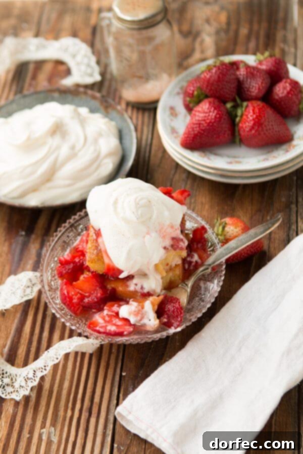 Generous serving of mascarpone whipped cream on strawberry shortcake