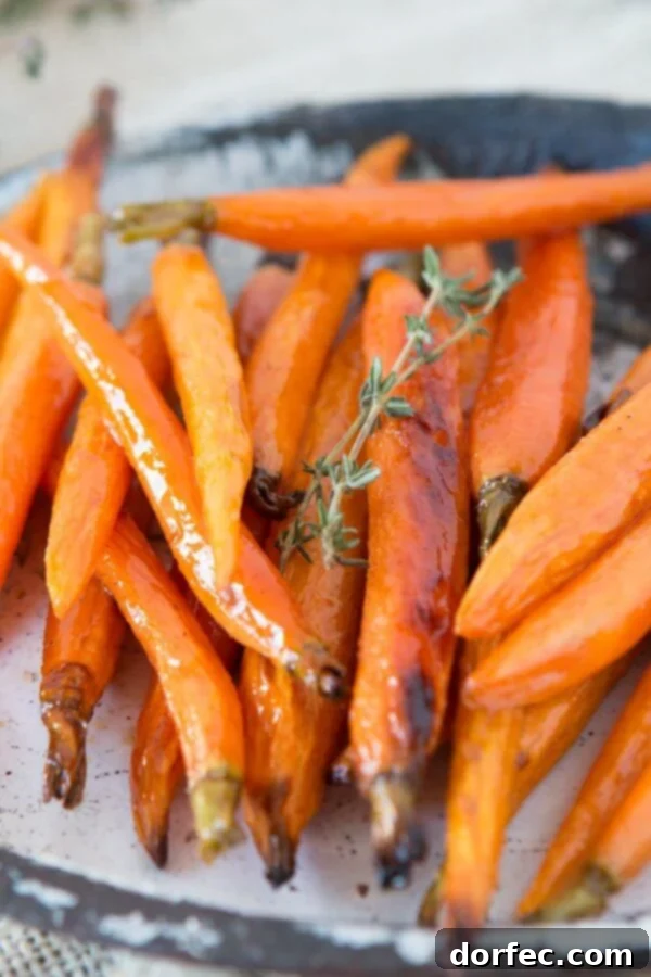 Delicious and easy honey roasted carrots, a beloved family side dish. Recipe by ohsweetbasil.com.