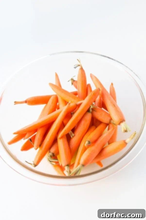 Simple and flavorful, these honey roasted carrots are a cherished family side. Discover the recipe at ohsweetbasil.com.