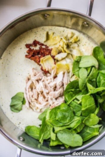 Pesto Chicken Pasta with Sun-Dried Tomatoes and Artichokes Creamy Pesto Pasta with Chicken and Flavorful Vegetables