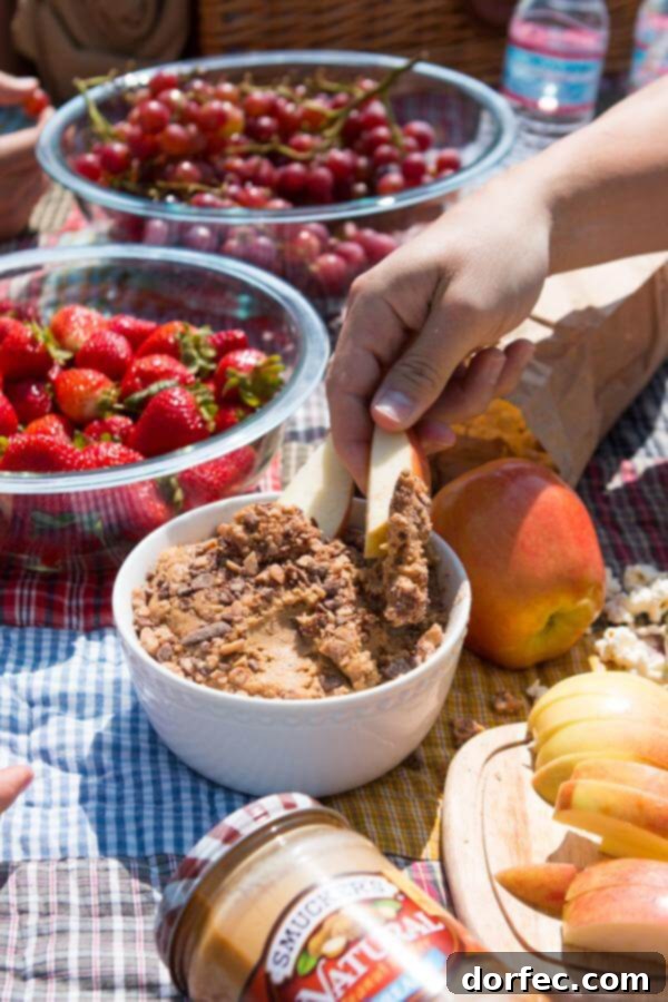 Close-up of Peanut Butter Toffee Apple Dip with apple slices and bananas, perfect for sharing