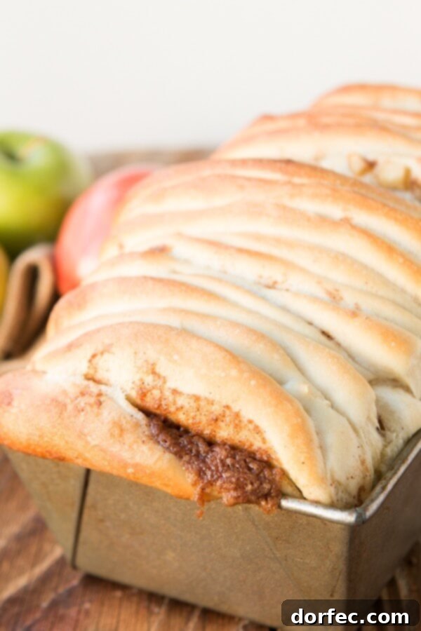 Apple Pie Pull Apart Bread with Maple Glaze - Irresistible Breakfast Treat Close-up of the delectable Apple Pie Pull Apart Bread with Maple Glaze, showcasing its golden-brown crust and sweet topping