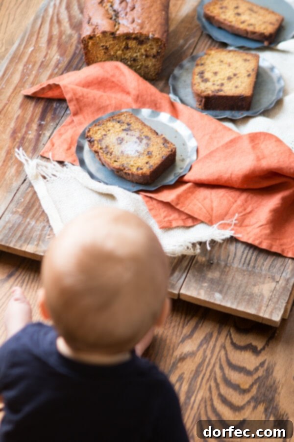 A close-up shot of a slice of pumpkin chocolate chip bread, warm and inviting.