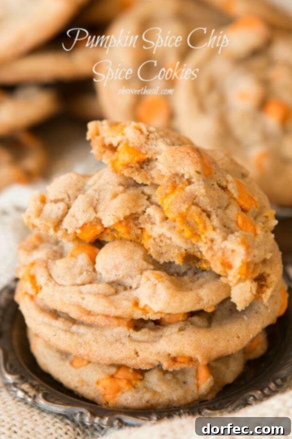 Deliciously soft and chewy pumpkin spice cookies loaded with festive pumpkin spice chips, perfect for your next Halloween party or fall gathering. Recipe by ohsweetbasil.com.