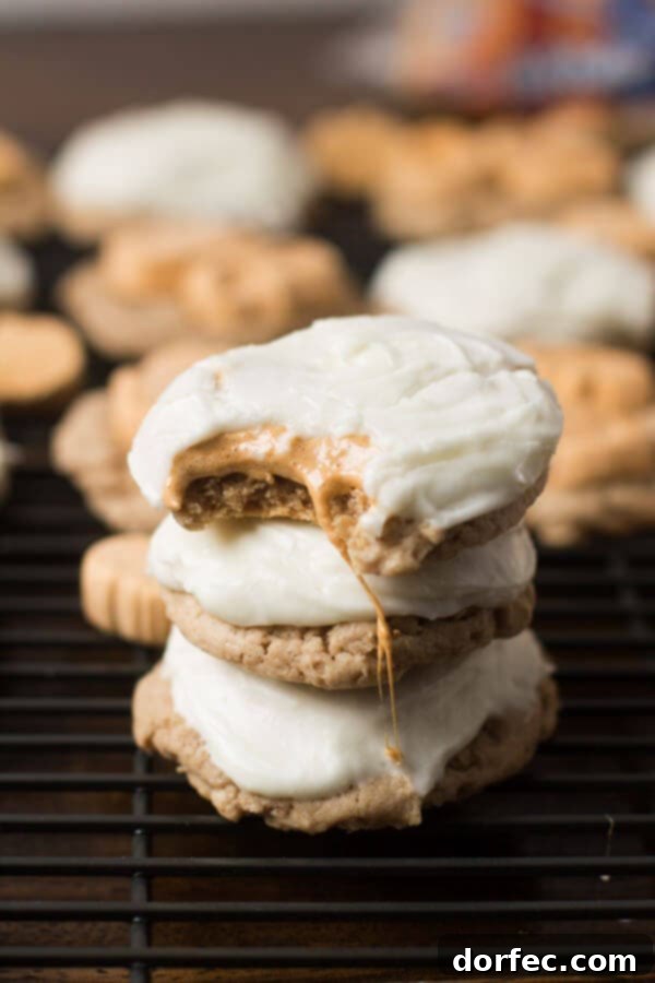 Easy 4-ingredient Pumpkin Spice Marshmallow Cookies with a delectable cream cheese frosting, perfect for quick holiday baking. From ohsweetbasil.com.