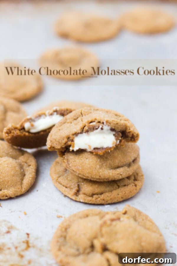 Warm molasses cookies, stuffed with creamy white chocolate and rolled in sparkling sugar, perfect for the holidays.
