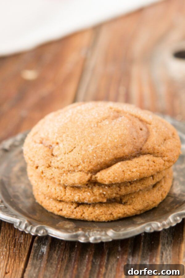 Soft-Baked Molasses Delights 3 Close-up of a stack of soft molasses cookies, showcasing their inviting chewy texture and perfectly crinkled tops.