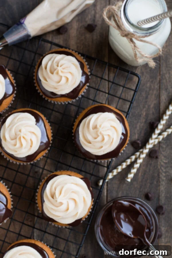 Close-up of a frosted Chocolate Covered Pumpkin Cupcake, showing rich chocolate ganache and cinnamon cream cheese frosting