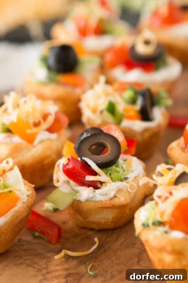 Quick and easy veggie pizza tarts with the best filling I've had for this easy appetizer ohsweetbasil.com I've had so many of these there wont be any left! Quick and Easy veggie pizza tarts appetizer ohsweetbasil.com