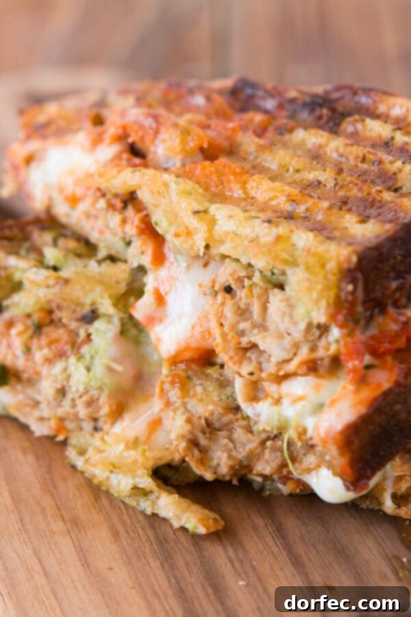 The Ultimate Pesto Meatball Panini: Your New Favorite Easy Dinner Close-up of a grilled Pesto Meatball Panini, showcasing melted cheese and saucy Italian meatballs. Perfect for a quick, gourmet family dinner.