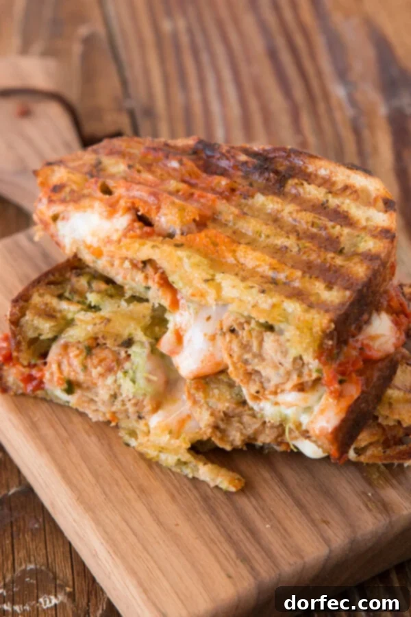How to Make a Delicious Pesto Meatball Panini for a Quick Meal Pesto Meatball Panini being grilled in a panini press, highlighting the golden-brown bread and the delicious filling. A perfect quick lunch or family meal.
