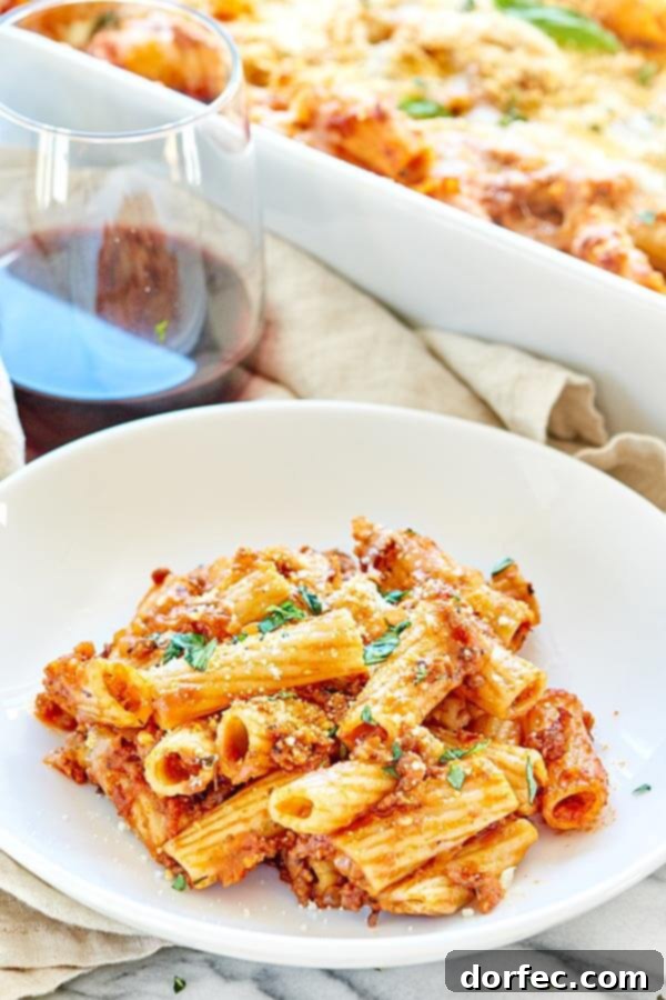 A hearty and cozy fall dinner featuring Spicy Sausage Rigatoni, a homemade spicy sausage marinara, and plenty of melted mozzarella. Perfect comfort food.