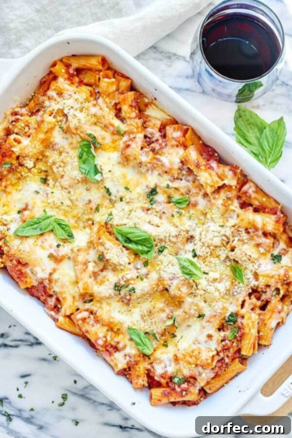 Close-up of Spicy Sausage Rigatoni, showing the chunky, homemade marinara with sausage, ready for baking with cheese. A perfect fall comfort food recipe.