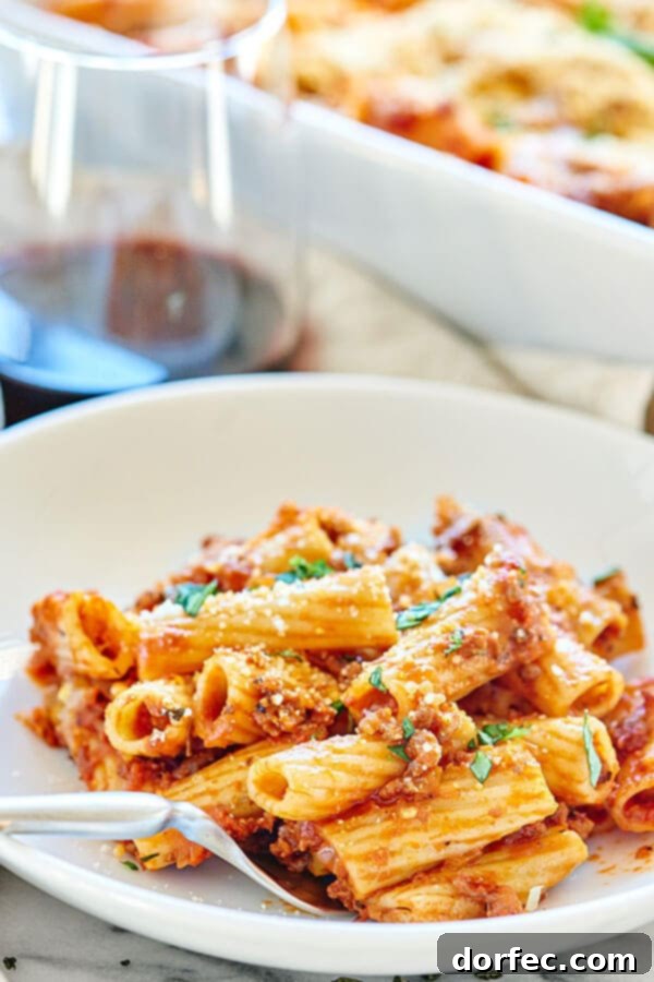 Another enticing view of Spicy Sausage Rigatoni, showcasing the rigatoni pasta coated in spicy sausage marinara sauce before being baked.